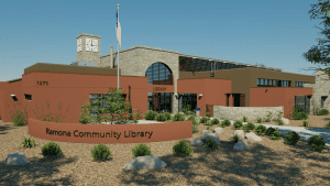 Exterior Render of a library with a large sign in front and foliage, a flag, and a clock