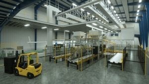 a factory floor with black and yellow machinery and a forklift with an operator