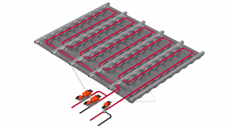 3D illustration of a radiant floor heating system showing red pipes laid in parallel loops under a gray floor, connected to orange pump units and black pipes.