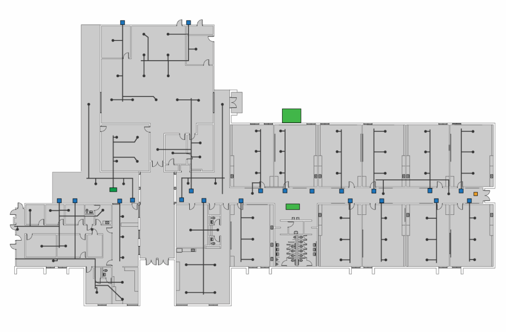 A floor plan of a building with multiple rooms and corridors, marked with black lines, icons, BAS graphics, and green and blue symbols indicating features or designations in various locations.