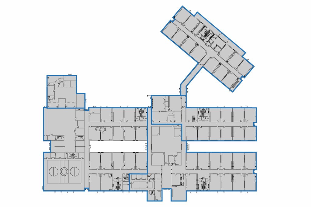 Floor plan of a large building features BAS graphics, with multiple rectangular rooms and corridors, including a long hallway leading to an additional section at the top right; rooms and shared spaces are clearly outlined.