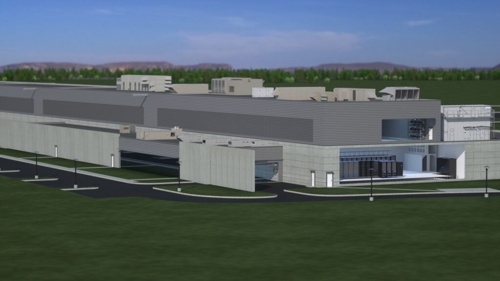 A large, modern industrial building with gray siding and rooftop equipment, surrounded by grass and trees, under a clear blue sky with distant hills—perfectly suited for data center graphics or visualizations requiring a high-tech setting.